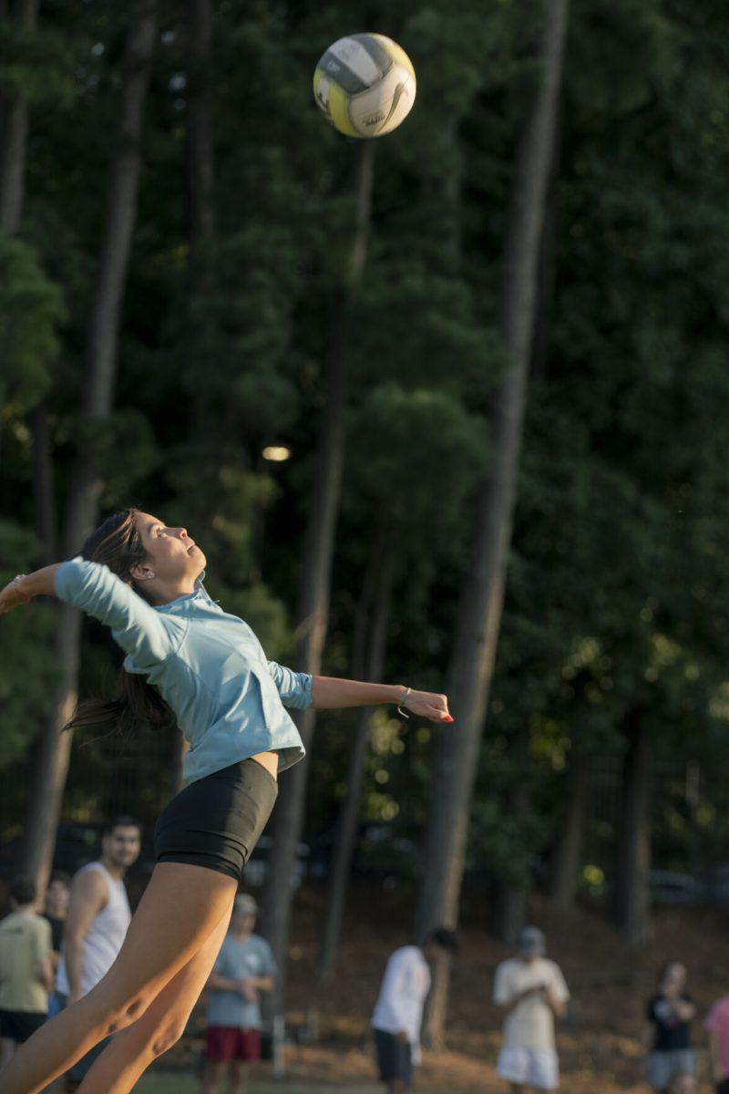 Kaylee Toro, a first-year studying life sciences, prepares to spike the ball at&#160;the Grass Volleyball Bash event on Miller Fields on Wednesday, Aug. 21, 2024. Grass Volleyball Bash was a Wolfpack Welcome Week event hosted by the men's and women's volleyball teams.