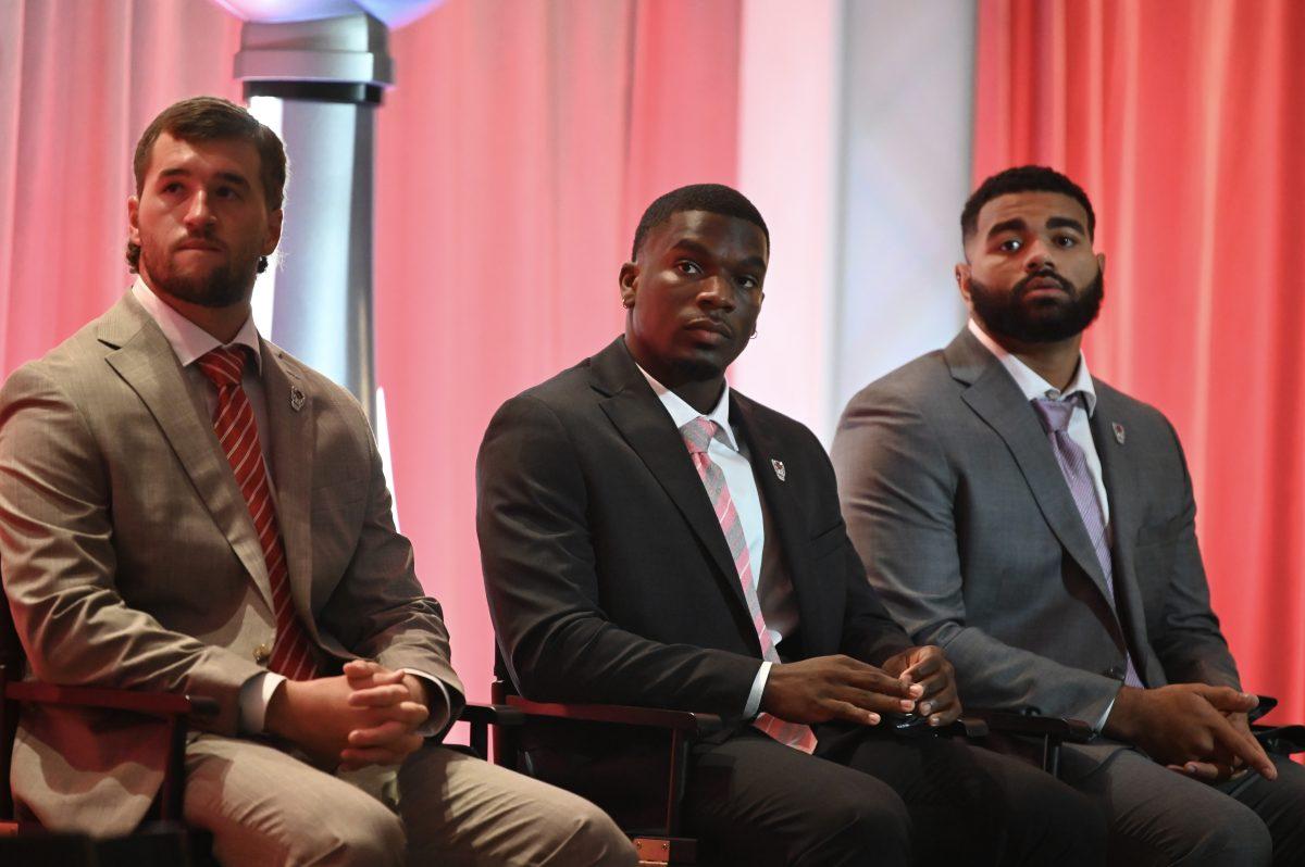 Graduate quarterback Grayson McCall (left), graduate running back Jordan Waters (middle) and senior defensive end Davin Vann (right) wait to speak during the ACC Kickoff in Charlotte, NC on Thursday, July 25, 2024. The three players alongside head coach Dave Doeren spoke as representitives of the NC State football team for the media day event.
