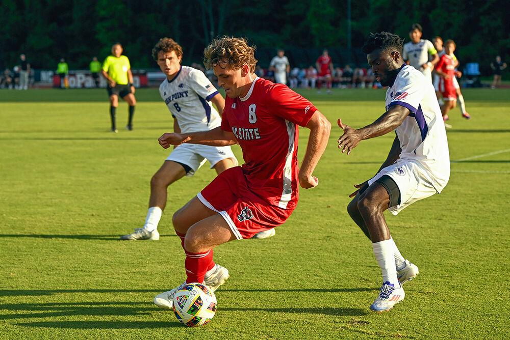 Senior Will Buete dribbles through High Point defenders during the match between the Wolfpack and the Panthers at Dail Soccer Field on Thursday, Aug. 22, 2024. Buete scored NC State&#8217;s first goal of the game. NC State beat High Point 3-2.