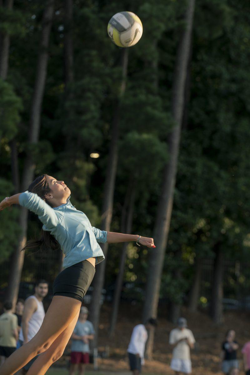 Kaylee Toro, a first-year studying life sciences, prepares to spike the ball at&#160;the Grass Volleyball Bash event on Miller Fields on Wednesday, Aug. 21, 2024. Grass Volleyball Bash was a Wolfpack Welcome Week event hosted by the men's and women's volleyball teams.