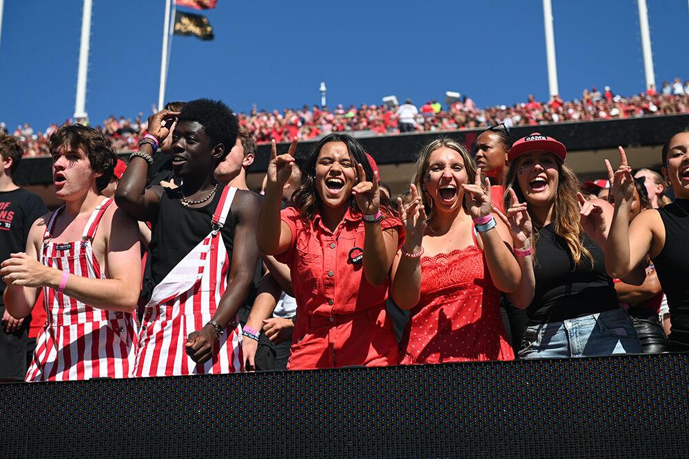 The NC State student sections yells and holds up "wolfies" during the game against Marshall at Carter-Finley Stadium on Saturday, Oct. 7, 2023. NC State beat Marshall 48-41.