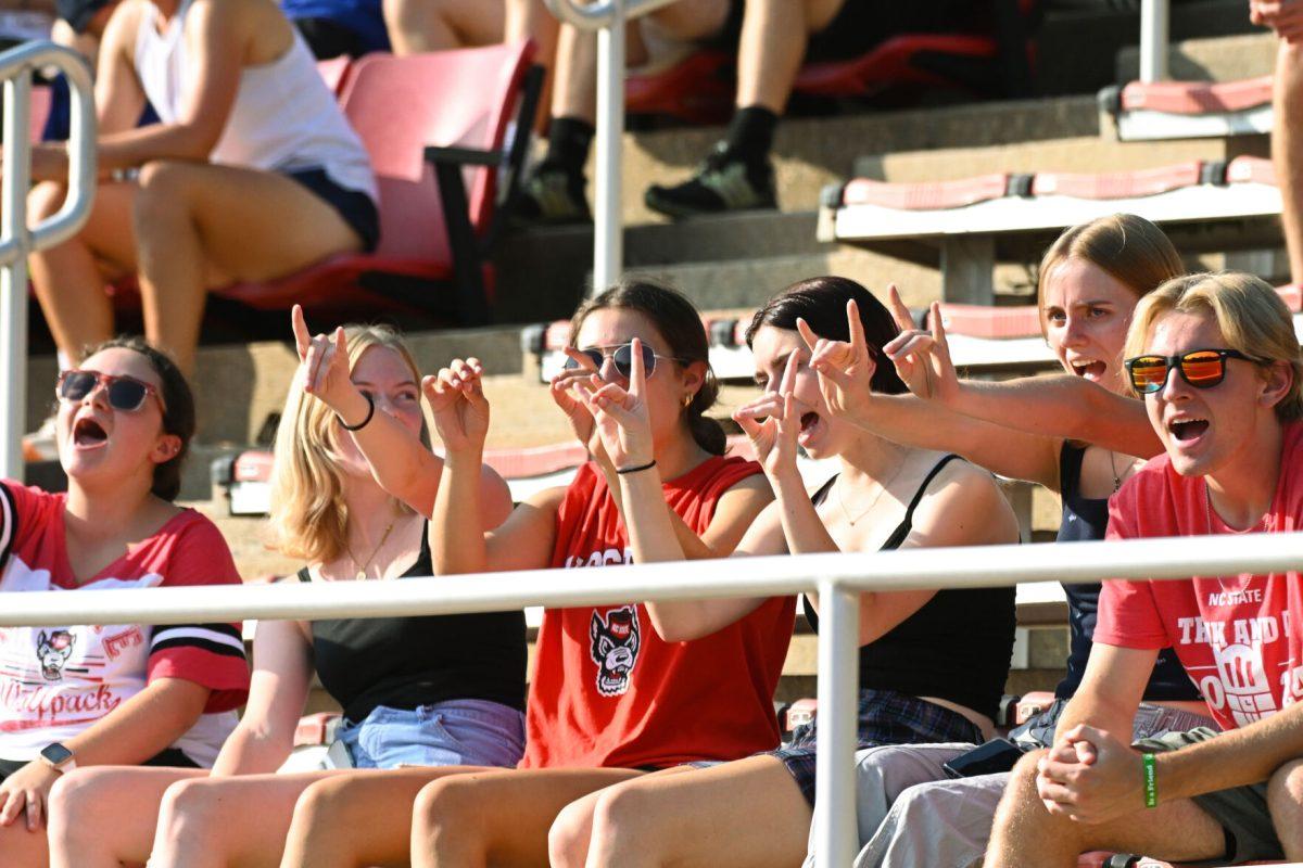 Wolfpack fans hold up "wolfies" while cheering during the match against Florida Gulf Coast University at Dail Soccer Field on Sunday, Aug. 25, 2024. NC State won 1-0.