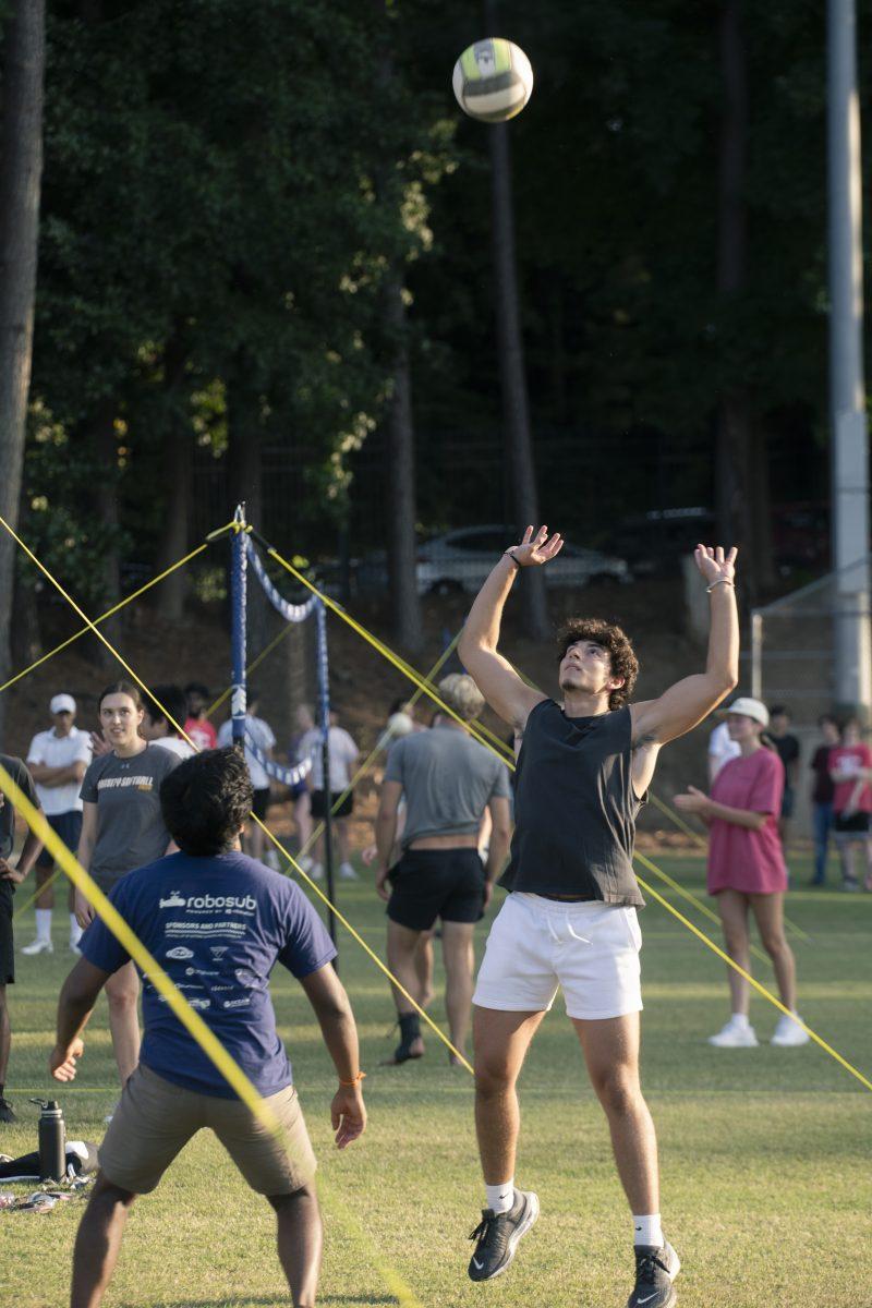 Rafael Agostini, a first-year studying life sciences, prepares to hit the ball at the Grass Volleyball Bash event on Miller Fields on Wednesday, Aug. 21, 2024. Grass Volleyball Bash was a Wolfpack Welcome Week event hosted by the men's and women's volleyball teams.