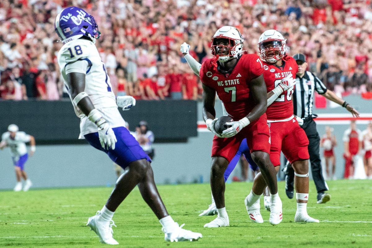 Graduate running back Jordan Waters stares down a defender after a run during the game against Western Carolina in Carter-Finley Stadium on Thursday, Aug. 29, 2024. Waters ran for two touchdowns. The Wolfpack defeated the Catamounts 38-21.