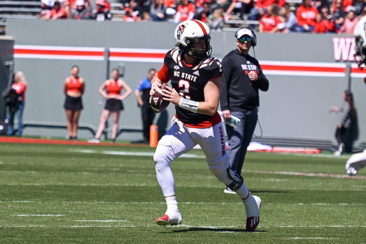 Graduate quarterback Grayson McCall looks to make a play during the spring game at Carter-Finley Stadium on Saturday, April 6, 2024. The Red team beat the White team 51-7.