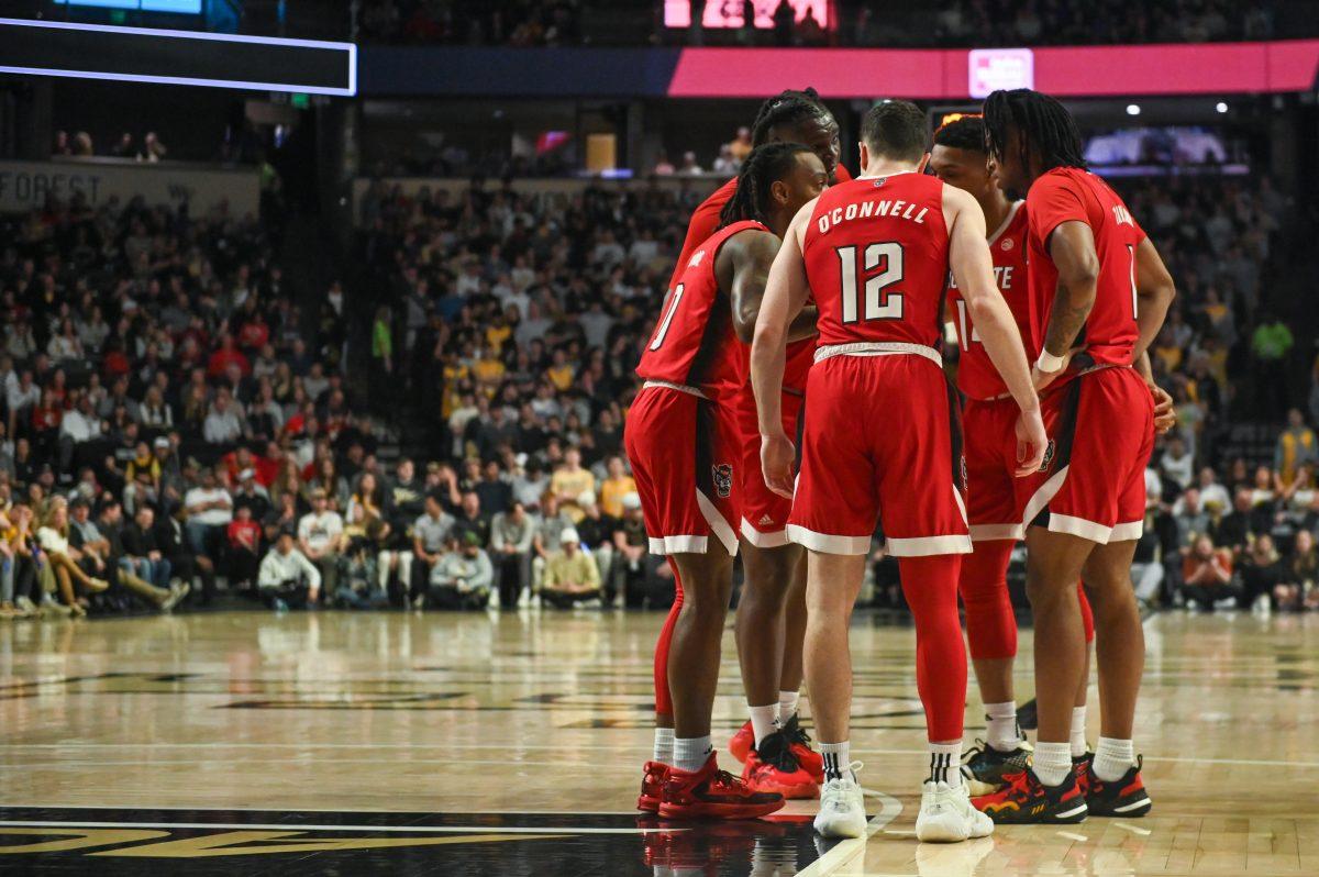 Members of the men's basketball team huddle up during the game against Wake Forest in Lawrence Joel Veterans Memorial Coliseum on Saturday, Feb. 10, 2024. The Wolfpack lost the game 83-79.