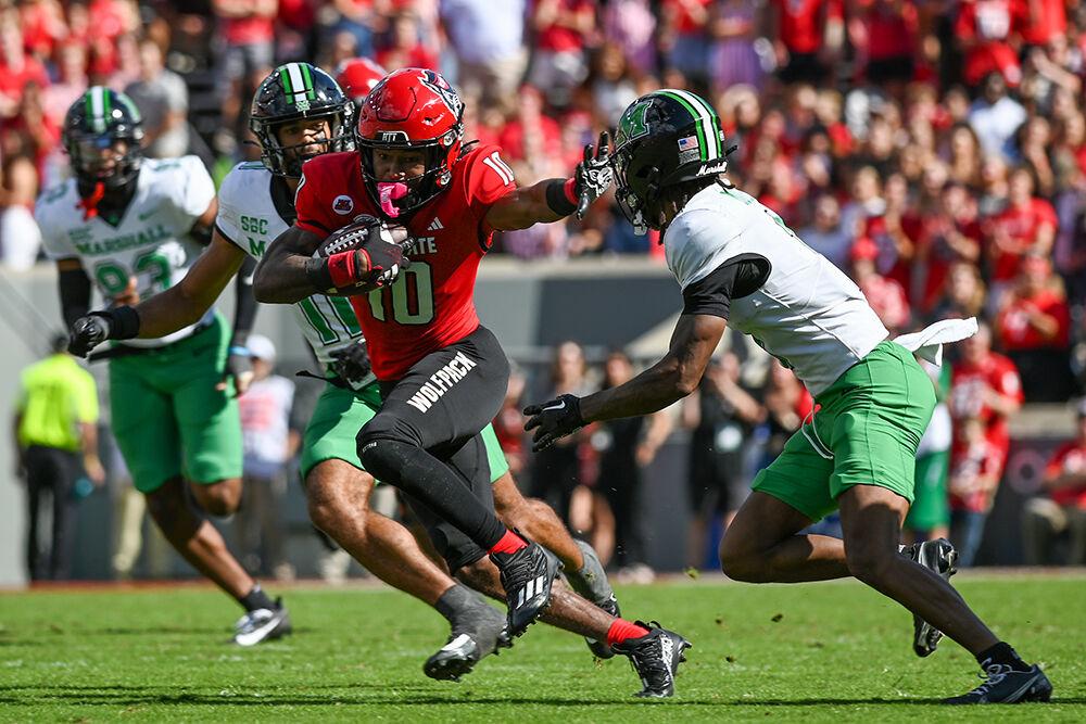 Freshman wide receiver Kevin Concepcion holds out his hand as he runs the ball down the field during the game against Marshall at Carter-Finley Stadium on Saturday, Oct. 7, 2023. Concepcion scored two touchdowns for the Wolfpack. NC State beat Marshall 48-41.