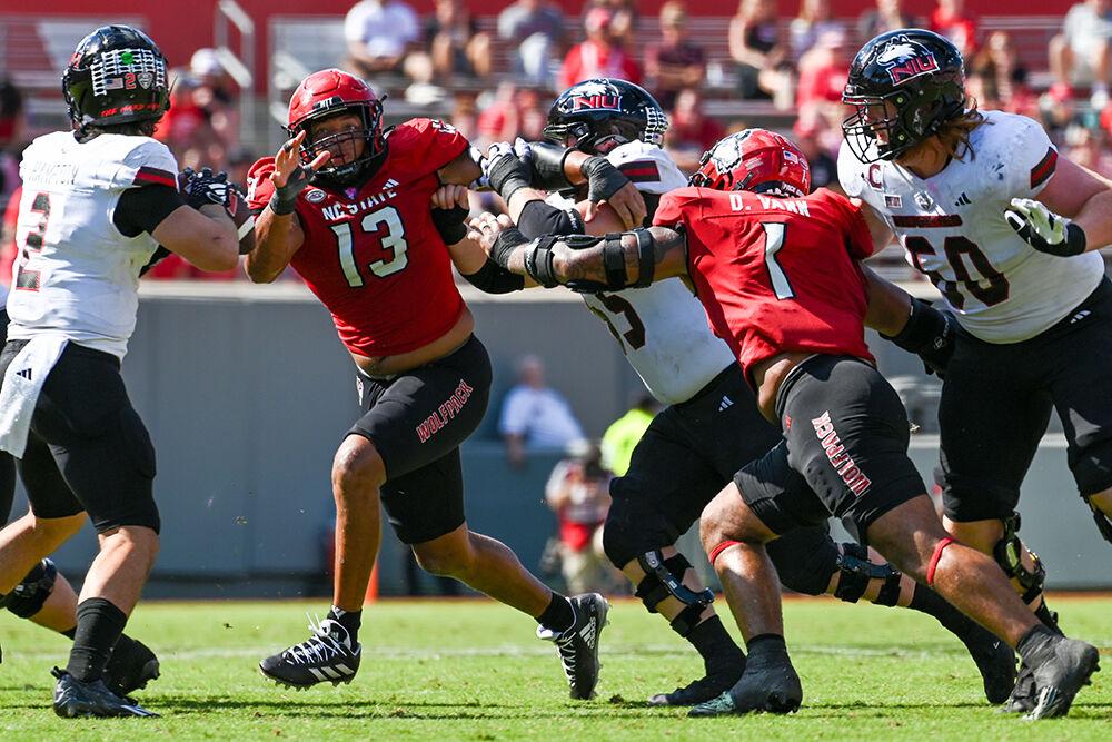 Redshirt junior defensive end Tavali Price and senior defensive back Davin Vann rush the quarterback during the football game against Northern Illinois at Carter-Finley Stadium on Saturday, Sept. 28, 2024. Vann finished with two forced fumbles and ten total tackles. The Wolfpack beat the Huskies 24-17.