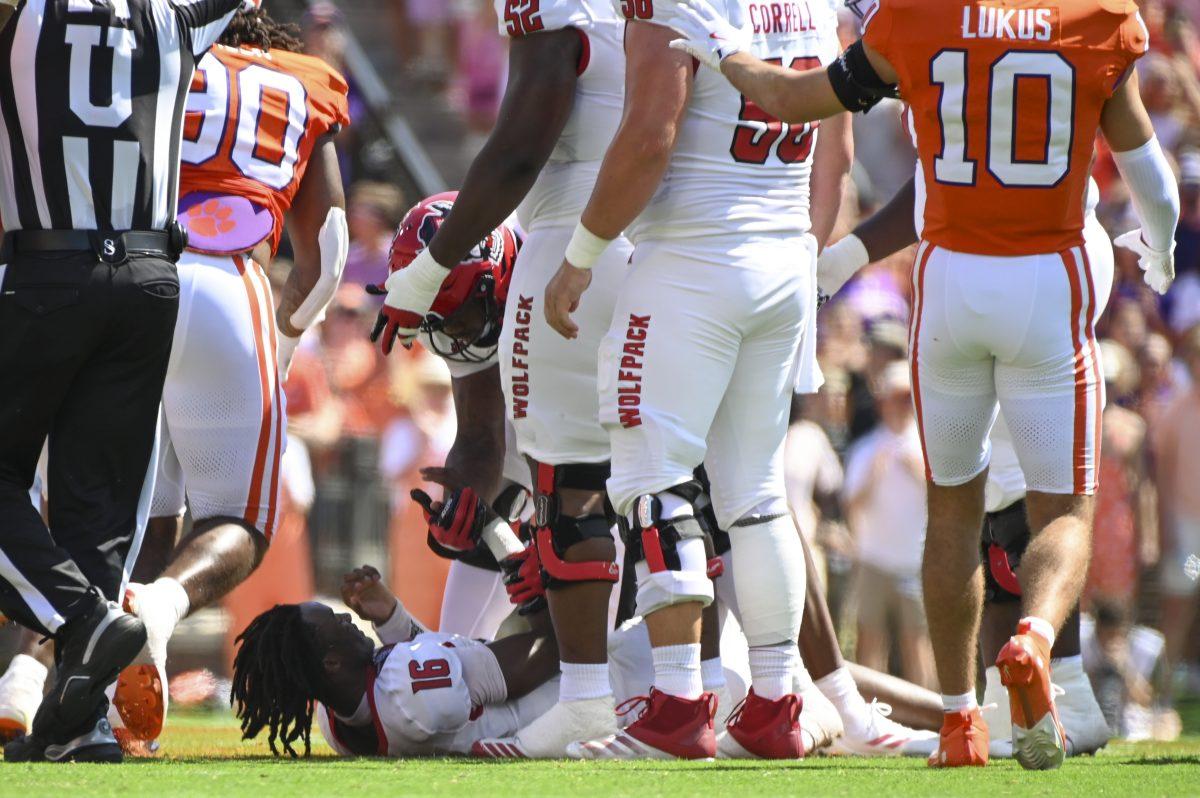 Freshman quarterback CJ Bailey gets picked up after getting sacked during the football game against Clemson in Memorial Stadium on Saturday, Sept. 21, 2024. Bailey was sacked twice. Clemson beat NC State 59-35.