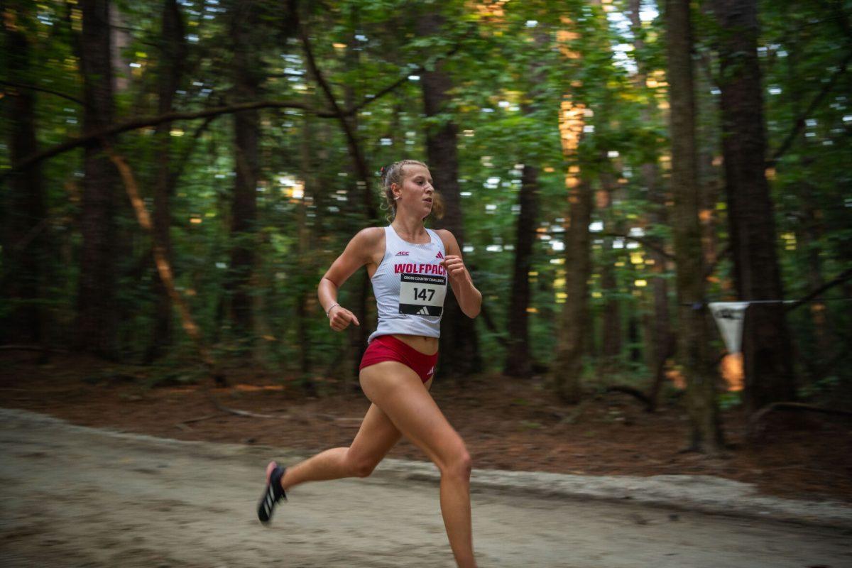 Sophomor Angelina Napoleon runs through the forest during the Adidas XC Challenge at WakeMed Soccer Park on Friday, Sept. 20, 2024. Napoleon finished with a time of 17:10.8. The NC State women's team finished in first place with a total of 34 points.