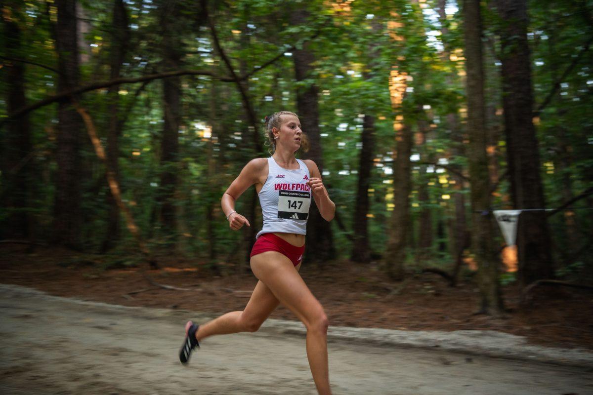 Sophomor Angelina Napoleon runs through the forest during the Adidas XC Challenge at WakeMed Soccer Park on Friday, Sept. 20, 2024. Napoleon finished with a time of 17:10.8. The NC State women's team finished in first place with a total of 34 points.