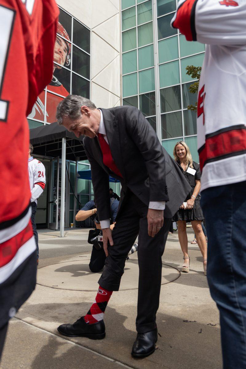 NC Governor Roy Cooper shows off his Carolina Hurricanes socks at the Lenovo Center unveiling on Thursday, Sept. 19, 2024. Governor Cooper spoke highly of Lenovo as they unveiled their new naming partnership.