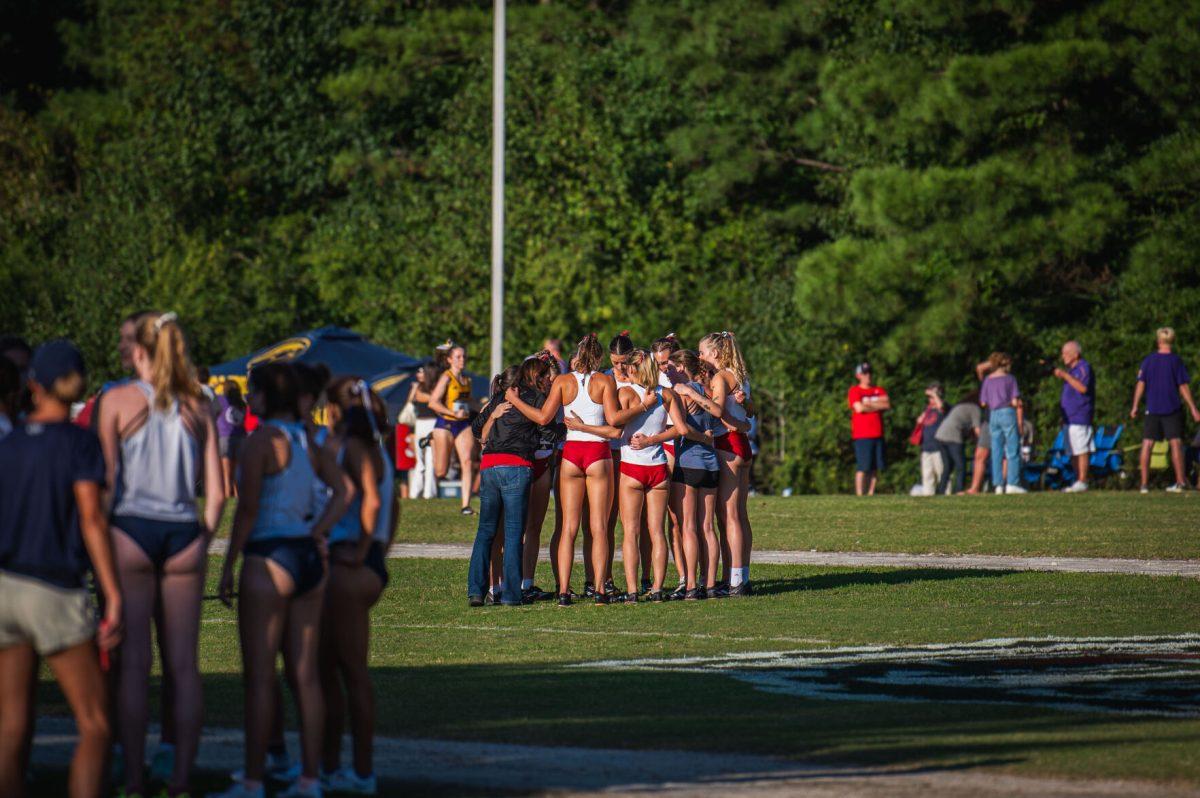 The NC State women's team huddles together before the Adidas XC Challenge at WakeMed Soccer Park on Friday, Sept. 20, 2024. The NC State women's team finished in first place with a total of 34 points.