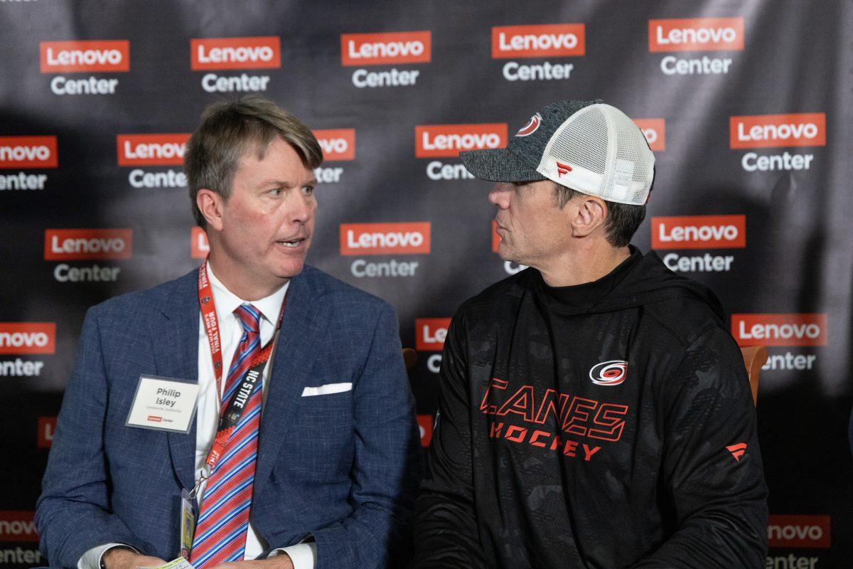 NC Centennial authority board member Philip Isley speaks with Carolina Hurricanes head coach Rod Brind'Amour at the Lenovo Center unveiling on Thursday, Sept. 19, 2024. The NC Centenial Authority is a joint commission that manages the newly remanded Lenovo Center.