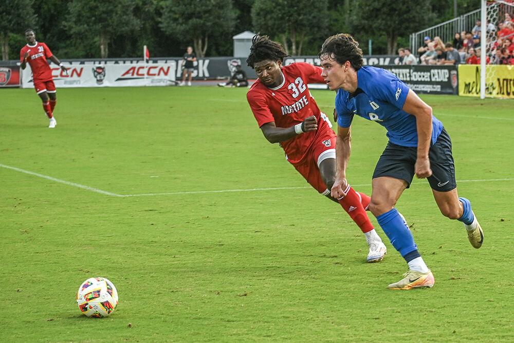 Sophomore forward Donavan Phillip tries to take the ball from his opponent during the match against Duke University at Dail Soccer Field on Friday, Sept. 27, 2024. NC State lost to Duke 2-1.