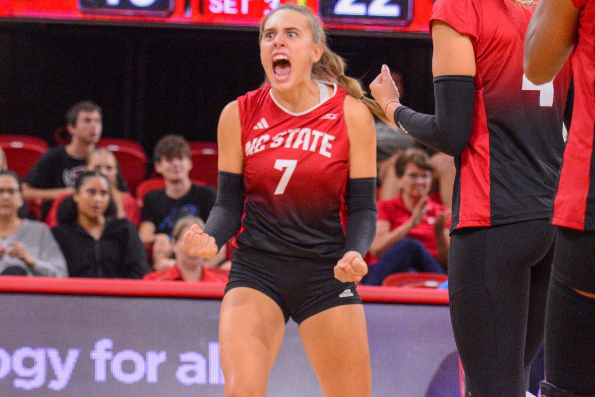 Junior Ava Brizard cheers during the match against Liberty in Reynolds Coliseum on Wednesday, Sept. 11, 2024. Brizard had 12 kills. The Wolfpack defeated the Flames 3-1.
