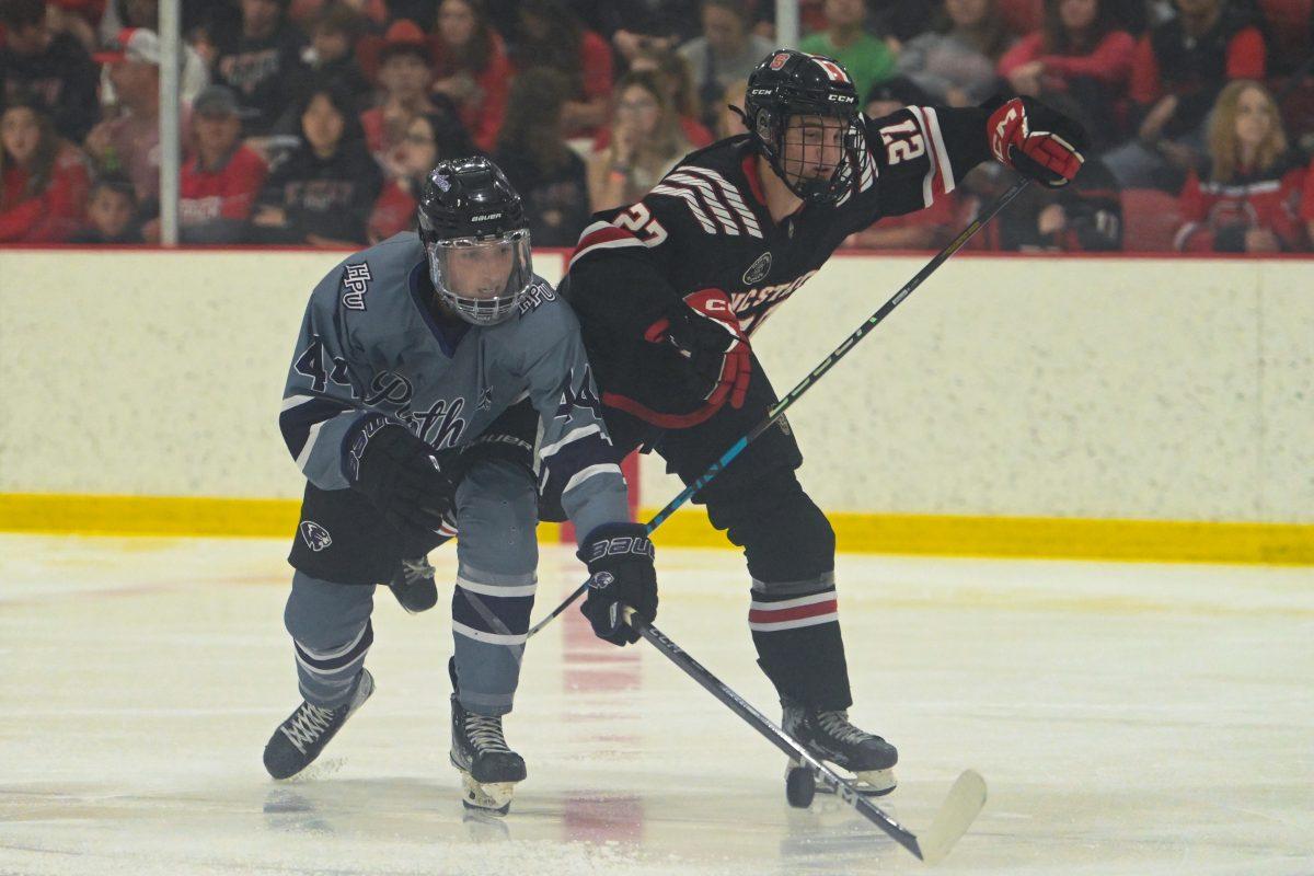 Sophomore forward Nick Shook fights for the puck during the game against High Point University at Invisalign Arena on Friday, Sept. 6, 2024. NC State won 8-2.