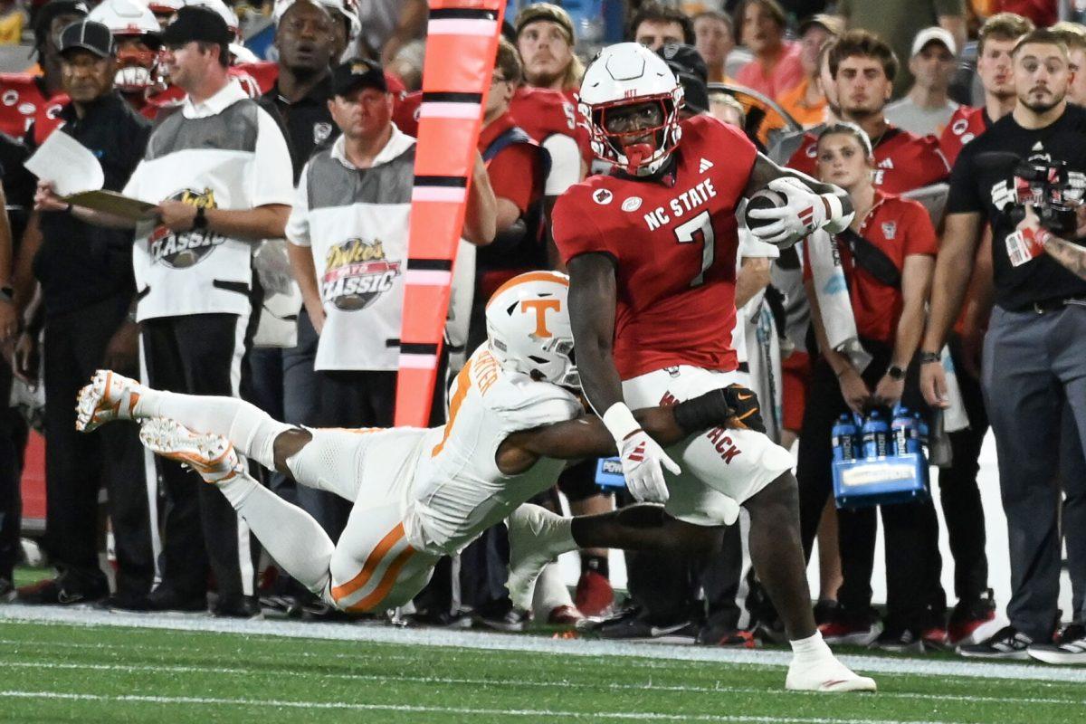Graduate running back Jordan Waters runs down the sideline during the Wolfpack's game against the Tennessee Volunteers in Bank of America Stadium for the Duke's Mayo Classic on Saturday, Sept. 8, 2024. The Wolfpack lost to the Volunteers 51-10.