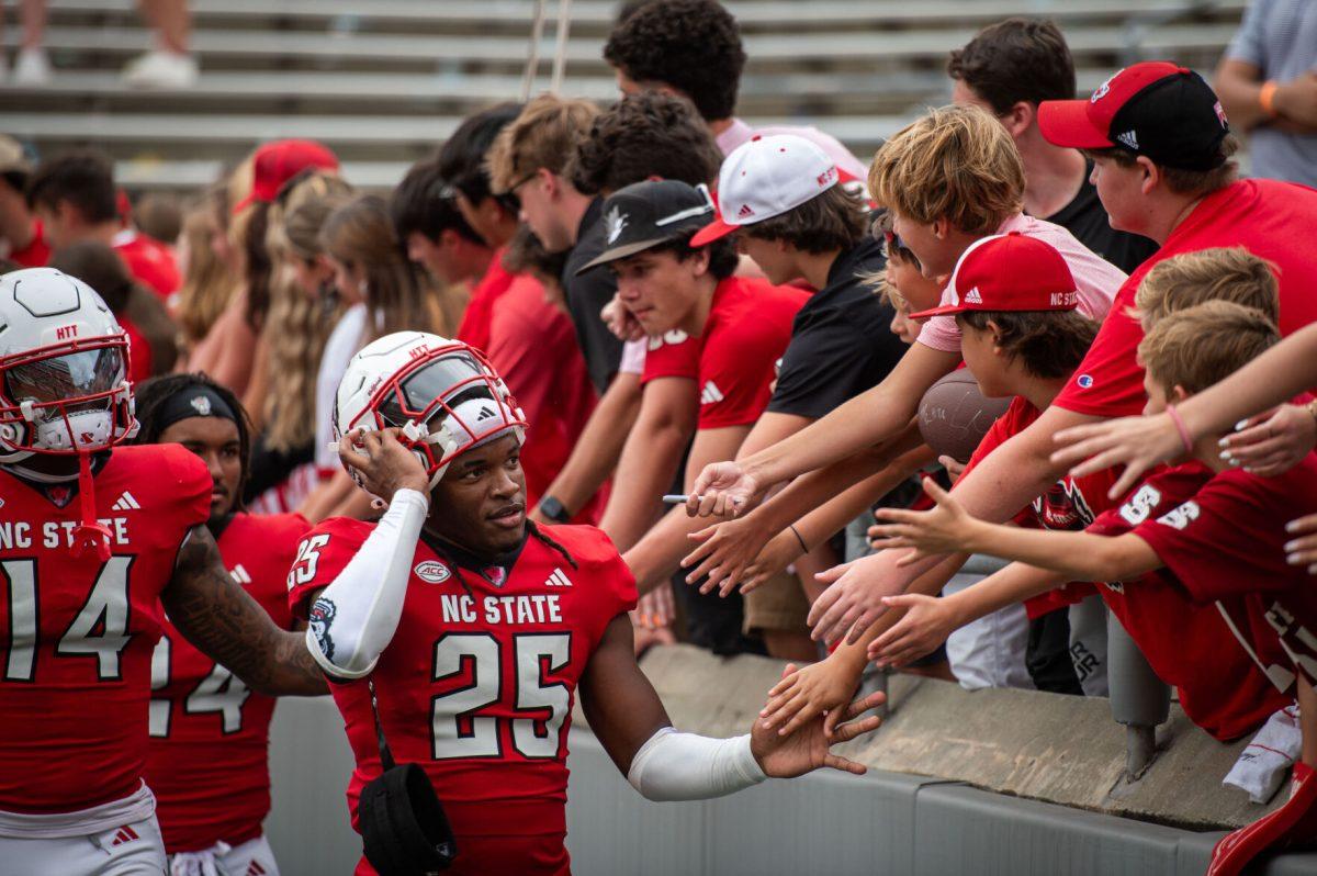 Freshman safety Ronnie Royal III high-fives fans after the game against LA Tech at Carter-Finley Stadium on Saturday, Sept. 14, 2024. The Wolfpack beat the Bulldogs 30-20