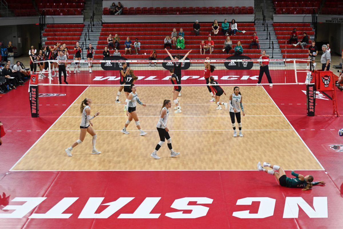 The NC State volleyball team celebrates a point scored during the game against Coastal Carolina in Reynolds Coliseum on Sunday, Sept. 22, 2024. The Wolfpack lost to the Chanticleers 3-2.