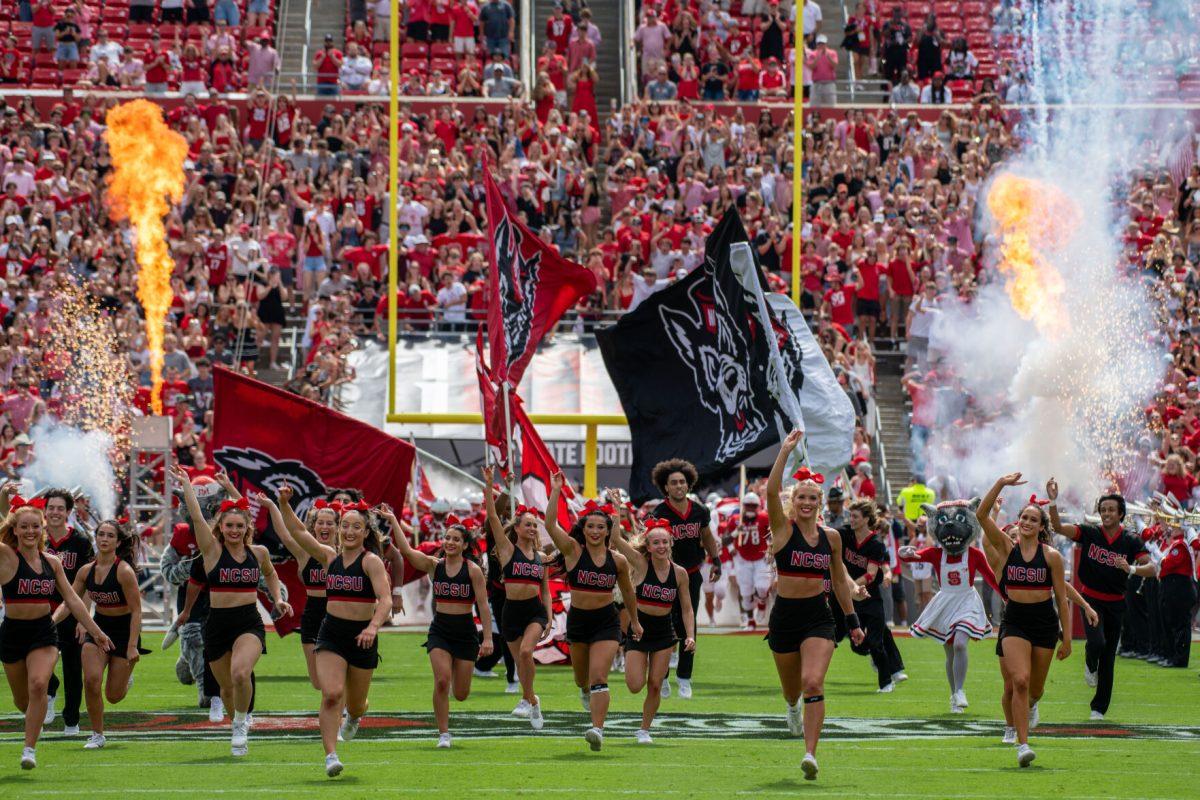 The NC State cheerleaders rush the field during the game against LA Tech at Carter-Finley Stadium on Saturday, Sept. 14, 2024. The Wolfpack beat the Bulldogs 30-20.