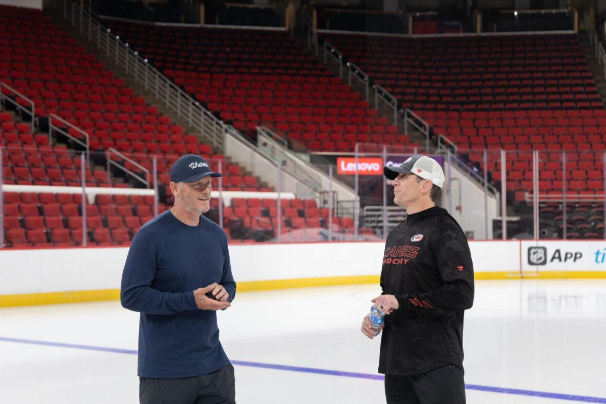 Carolina Hurricanes owner Tom Dundon and head coach Rod Brind'Amour chat on the ice at the Lenovo Center unveiling on Thursday, Sept. 19, 2024. The two have been working together since Tom Dundon became the majority owner of the team in Jan. 2018.