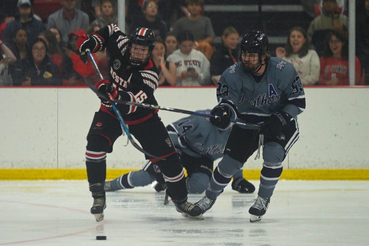 Senior defenseman Alex James battles for the puck during the game against High Point University at Invisalign Arena on Friday, Sept. 6, 2024. NC State won 8-2.