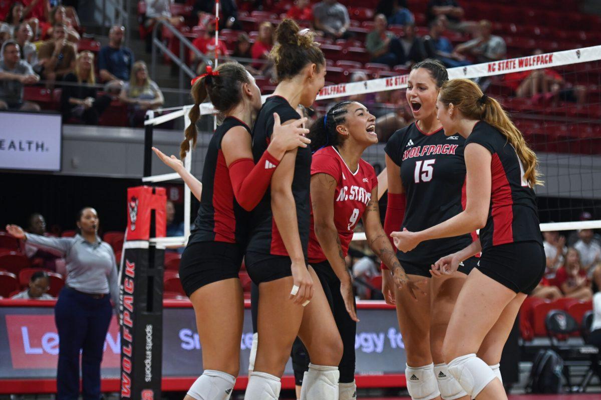 The NC State volleyball team celebrates a point scored during the game against Coastal Carolina in Reynolds Coliseum on Sunday, Sept. 22, 2024. The Wolfpack lost to the Chanticleers 3-2.