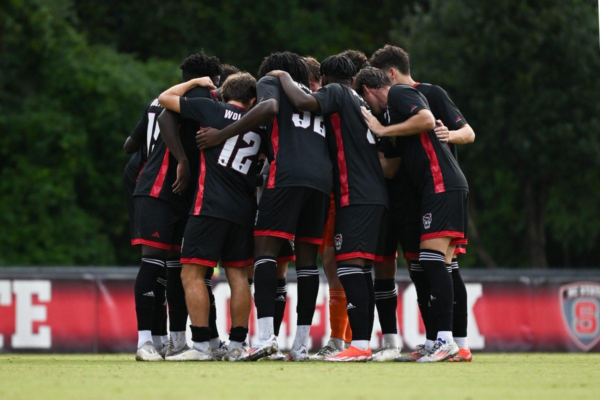 The NC State Wolfpack men's soccer team huddles together before their home game versus the Stetson Hatters at Dail soccer Field on Friday, Sept. 13. 2024. The Wolfpack went on to tie the Hatters 1-1.