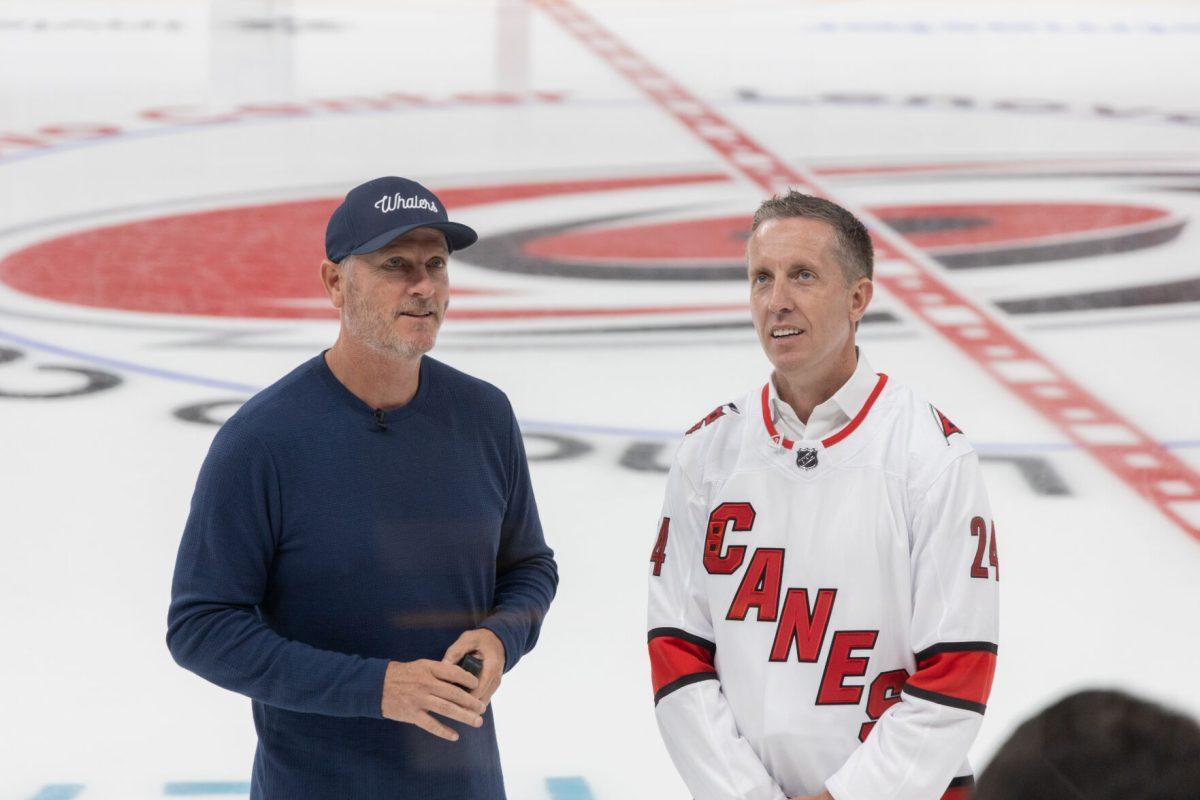 Carolina Hurricanes owner Tom Dundon and Lenovo&#8217;s, SVP and President of North America, Ryan McCurdy talk on the ice at the Lenovo Center unveiling on Thursday, Sept. 19, 2024. The event marks the beginning of Lenovo's ten-year naming rights agreement.