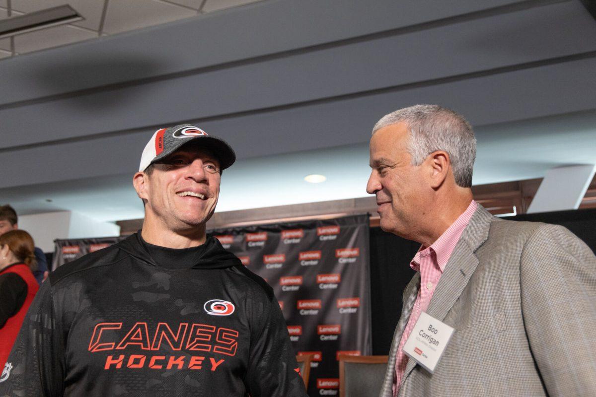 Carolina Hurricanes head coach Rod Brind'Amour speaks with NC State athletic director Boo Corrigan at the Lenovo Center unveiling on Thursday, Sept. 19, 2024. NC State men's basketball and the Carolina Hurricanes both share full-time use of The Lenovo Center.
