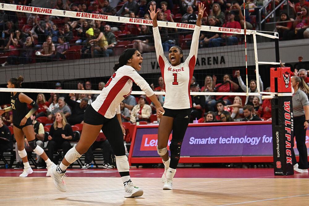 The NC State volleyball team celebrates after scoring a point during the match against Wake Forest in Reynolds Coliseum on Friday, Oct. 13, 2023. The Wolfpack defeated the Demon Deacons 3-1.