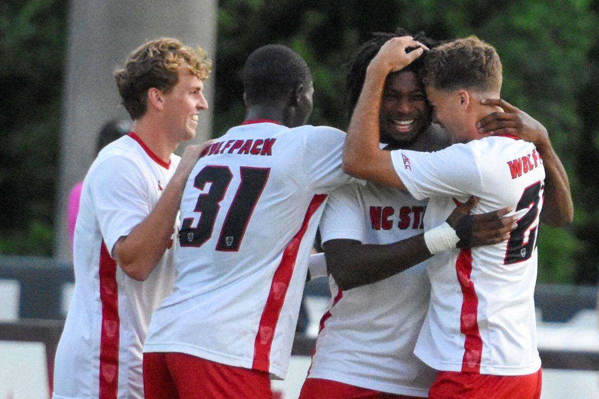 Sophomore forward Donavan Phillip is embraced by his teammates after the goal during the soccer game against Winthrop at Dail Soccer Field on Tuesday, Sept. 10, 2024. Phillip scored the second goal against Winthrop. The Wolfpack beat the Eagles 7-0.