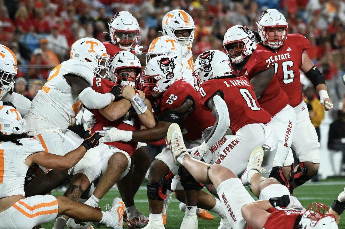 Graduate quarterback Grayson McCall is stopped before the first down marker by the Volunteers' defensive line during the Wolfpack's game against the Tennessee Volunteers in Bank of America Stadium for the Duke's Mayo Classic on Saturday, Sept. 8, 2024. The Wolfpack lost to the Volunteers 51-10.