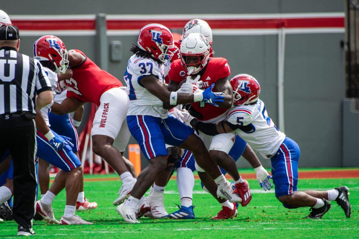 Graduate running back Jordan Waters charges through the defenders during the game against LA Tech at Carter-Finley Stadium on Saturday, Sept. 14, 2024. Waters had 36 rushing yards during the game. The Wolfpack beat the Bulldogs 30-20.