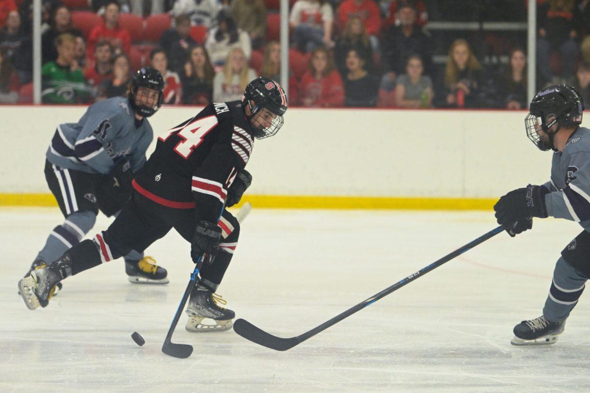 Junior forward Austin Finch moves the puck during the game against High Point University at Invisalign Arena on Friday, Sept. 6, 2024. NC State won 8-2.