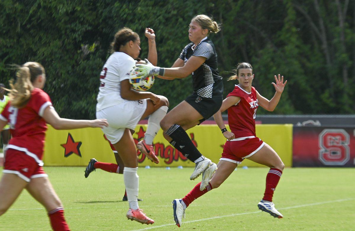 Junior goalkeeper Olivia Pratapas jumps to catch the ball during the match againt Stanford University at Dail Soccer field on Sunday, Sept. 22, 2024. NC State lost to Stanford 2-0.