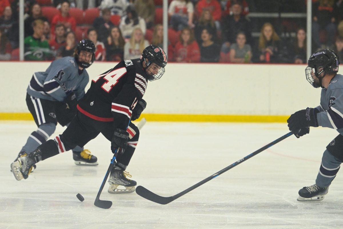 Junior forward Austin Finch moves the puck during the game against High Point University at Invisalign Arena on Friday, Sept. 6, 2024. NC State won 8-2.