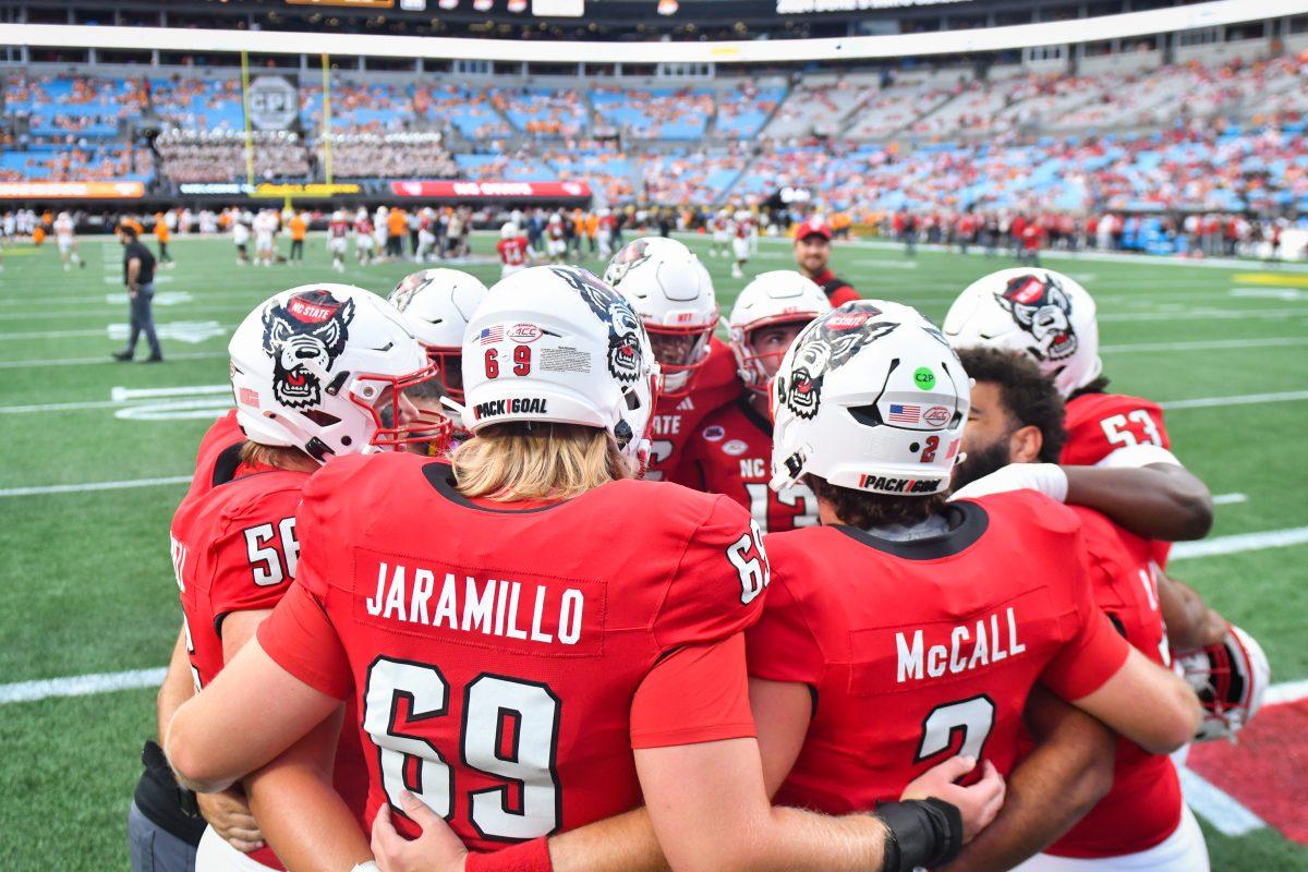 NC State players huddle up before the Wolfpack's game against the Tennessee Volunteers in Bank of America Stadium for the Duke's Mayo Classic on Saturday, Sept. 8, 2024. The Wolfpack lost to the Volunteers 51-10.