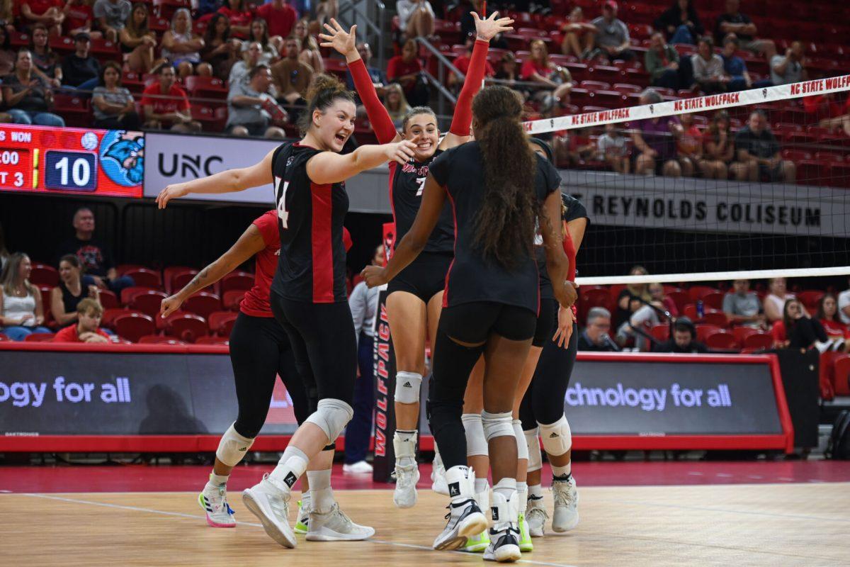 The NC State volleyball team celebrates a point during the game against Coastal Carolina in Reynolds Coliseum on Sunday, Sept. 22, 2024. The Wolfpack lost to the Chanticleers 3-2.