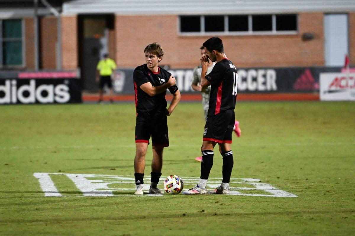 Junior center attacking midfielder Taig Healy and senior midfielder/forward Henrique Santos discuss free-kick strategy during the Wolfpack's home game against the Stetson Hatters at Dail Soccer Field on Friday, Sept. 13, 2024. The Wolfpack went on to tie the Hatters 1-1.