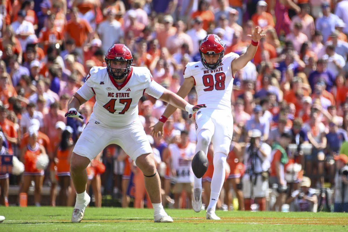 Redshirt junior punter Caden Noonkester kicks during the football game against Clemson in Memorial Stadium on Saturday, Sept. 21, 2024. Noonkester punted the ball four times for a total of 164 yards.&#160;Clemson beat NC State 59-35.