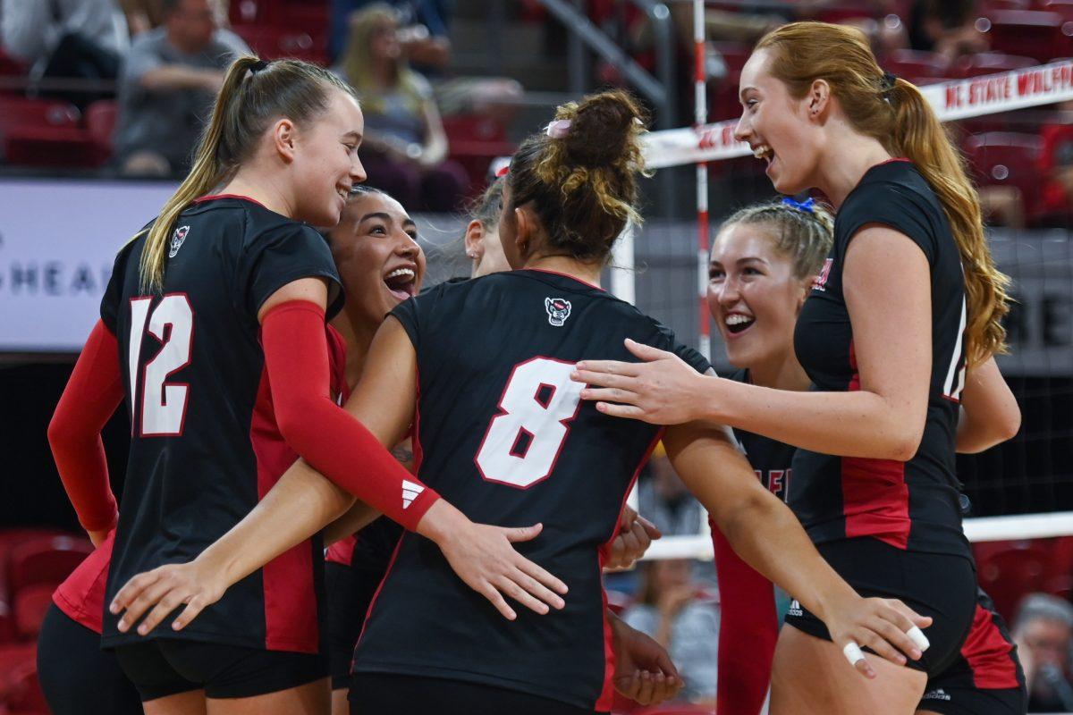 The NC State volleyball team celebrates a point during the game against Coastal Carolina in Reynolds Coliseum on Sunday, Sept. 22, 2024. The Wolfpack lost to the Chanticleers 3-2.