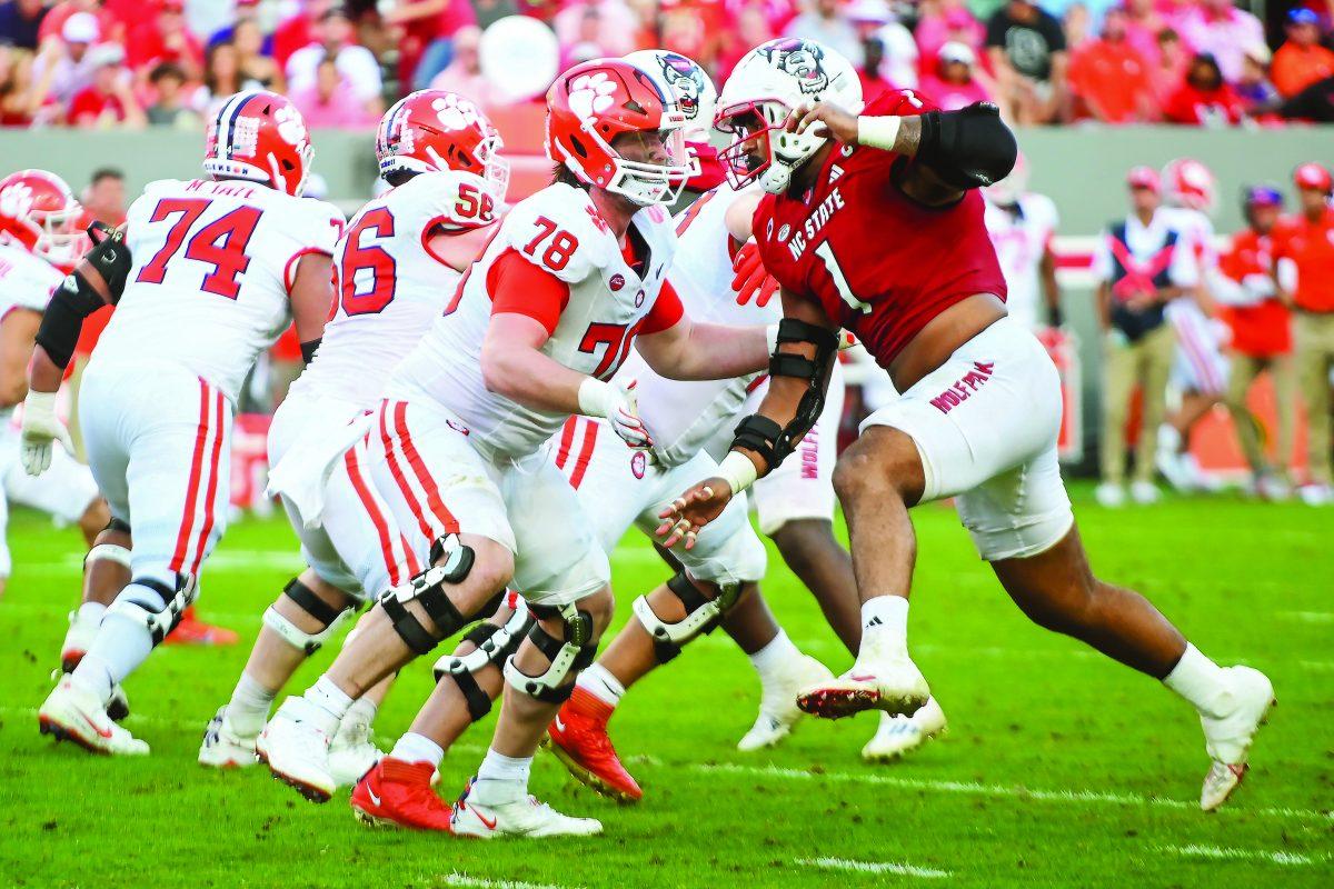 Junior defensive tackle Davin Vann prepares to tackle an opponent during the game versus Clemson on Saturday, Oct. 28, 2023 at Carter-Finley Stadium. NC State beat Clemson 24-17.