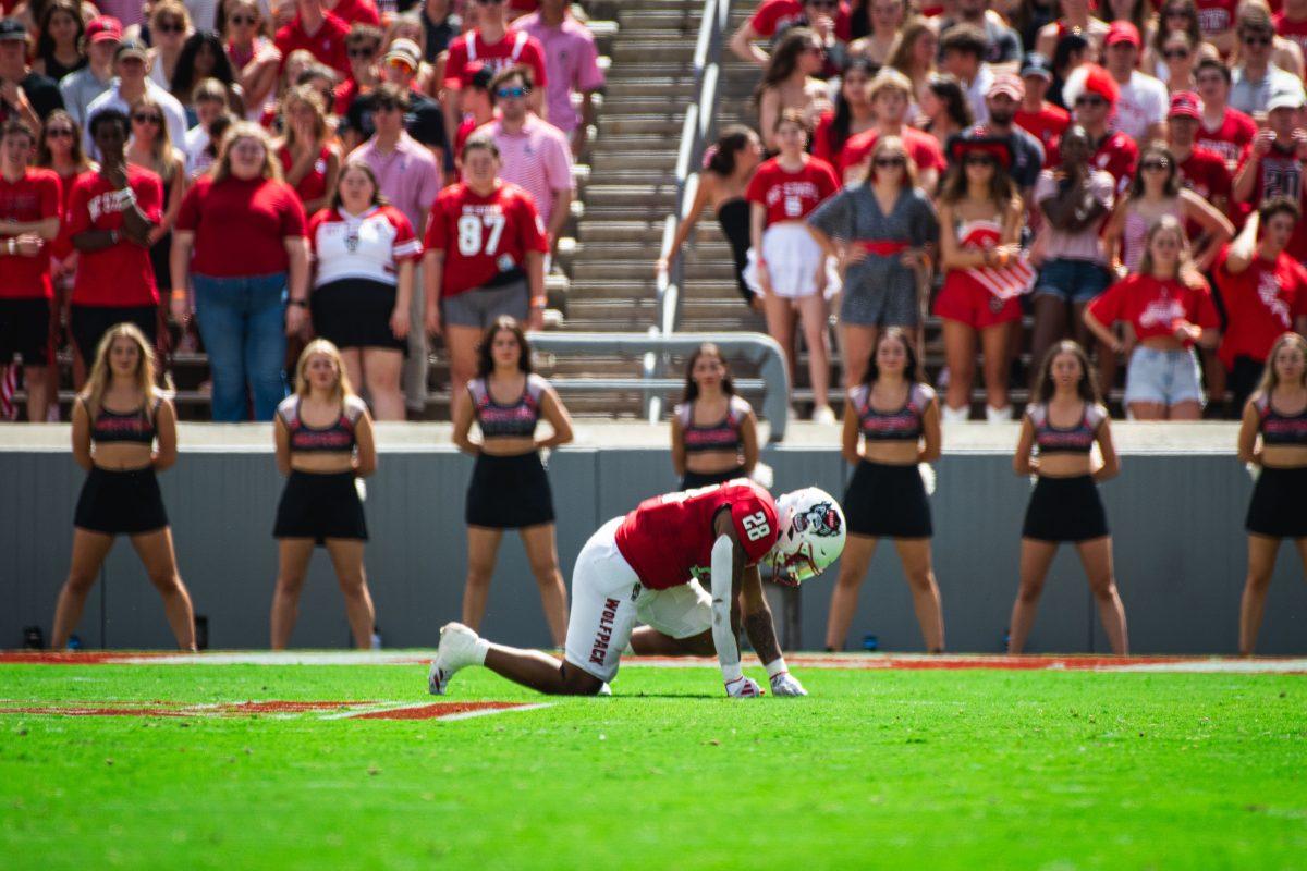 Redshirt senior running back Demarcus Jones II kneels in pain after suffering an injury during the game against LA Tech at Carter-Finley Stadium on Saturday, Sept. 14, 2024. The Wolfpack beat the Bulldogs 30-20