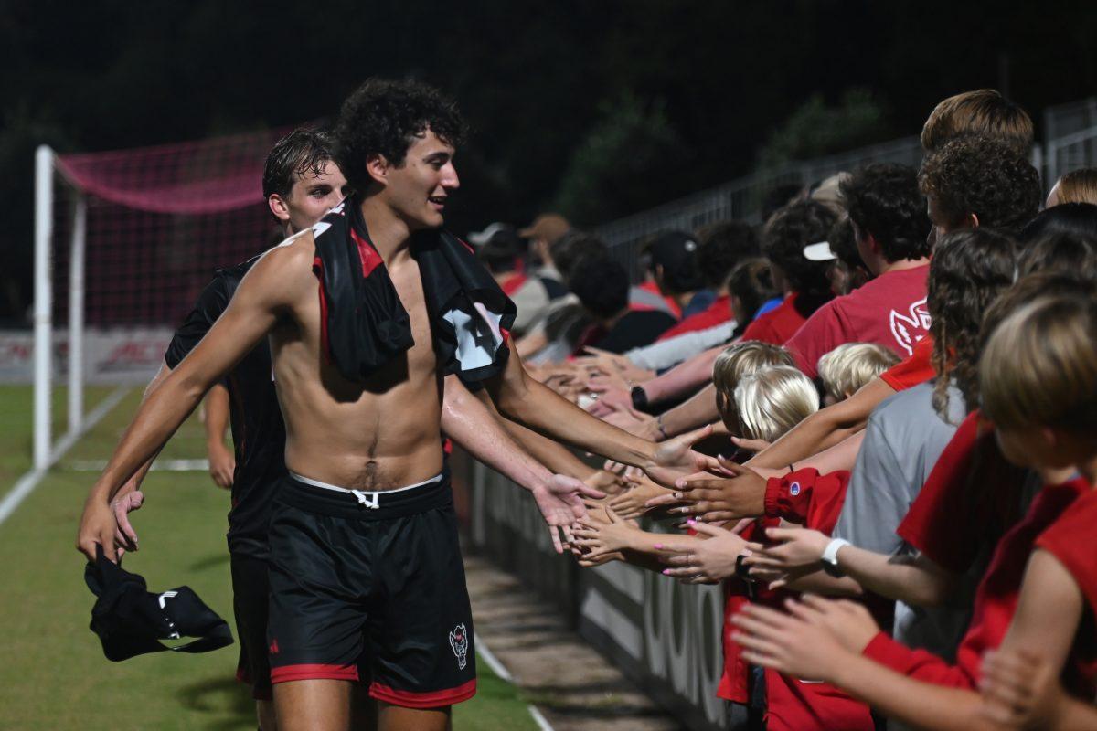 5th year senior midfielder/forward Eitan Rosen high fives fans after NC State's game against Stetson University at Dail Soccer Field on Friday, Sept. 13, 2024. The Wolfpack tied the Hatters 1-1.