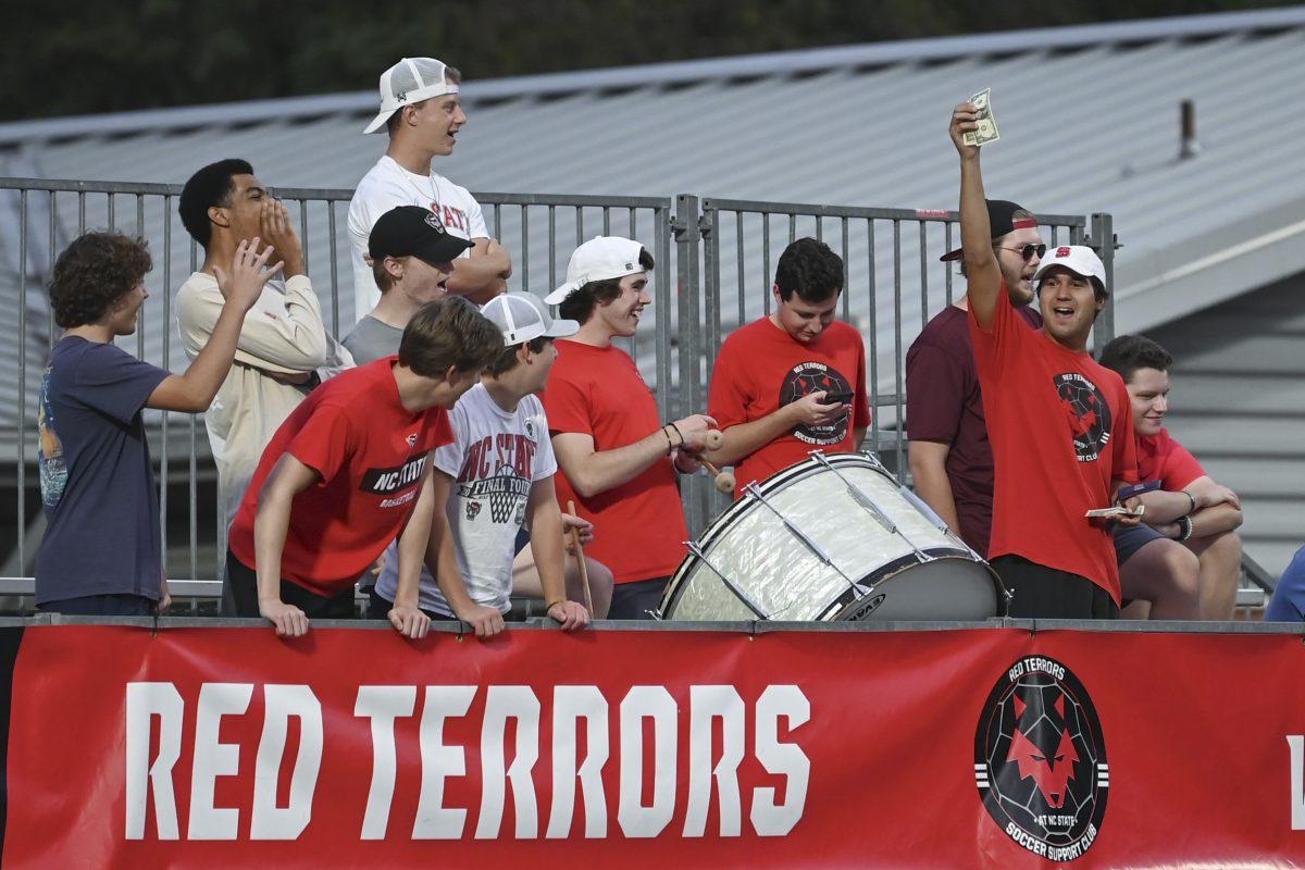 NC State students in the student section chant and hold money in the air as a prop during the match against William &amp; Mary at Dail Soccer Field on Thursday, Sept. 12, 2024. There were 430 people in attendance to watch the match. NC State lost to William &amp; Mary 1-0.