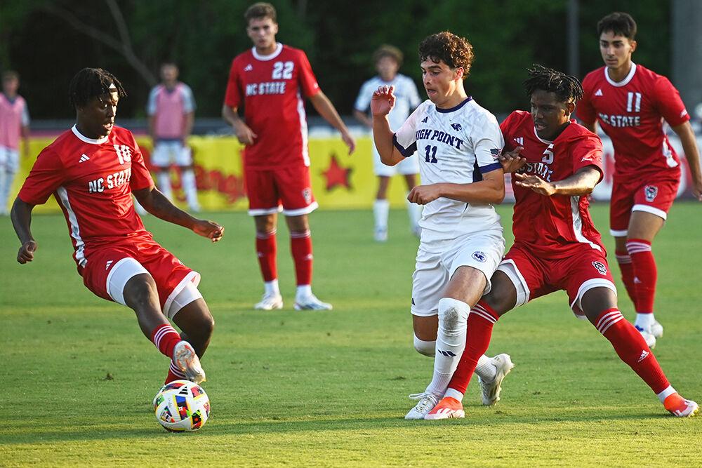 Senior midfielder Vusumzi Plamana and fifth-year midfielder Junior Nare battle an opponent for the ball during the match versus High Point at Dail Soccer Field on Thursday, Aug. 22, 2024. Plamana scored one goal for NC State. NC State beat High Point 3-2.