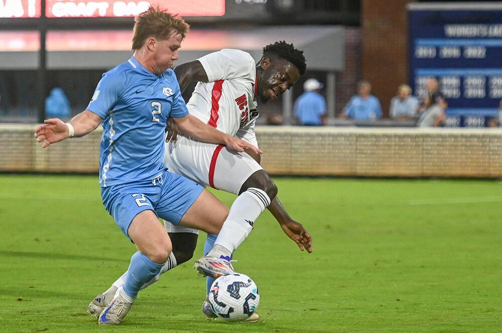 Senior defender Yves Tcheuyap struggles against an opponent during the match against UNC-Chapel Hill at Dorrance Field on Friday, Sept. 20, 2024. NC State lost the match 2-0.