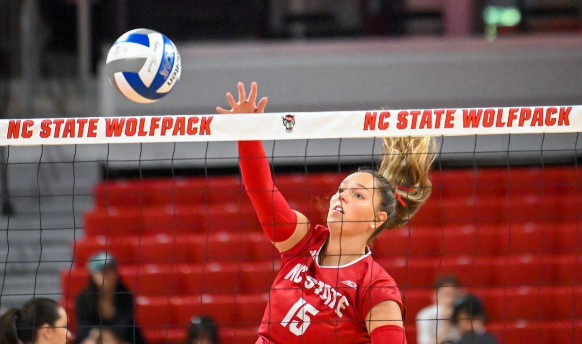 Junior middle blocker Lily Cropper spikes the ball over the net during the match against Virginia in Reynolds Coliseum on Sunday, Sept. 29, 2024. NC State beat Virginia 3-1.